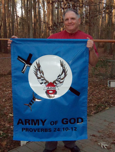 Donald Spitz holds Army of God banner.