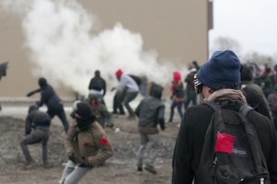 Students throw rocks at Surete du Quebec officers amidst tear gas during demo at Quebec Liberal Party Convention, 4 May 2012. Image Darren Ell..jpg