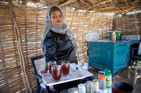 Sudanese woman serving tea