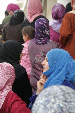Women with colourful headscraves in a crowd