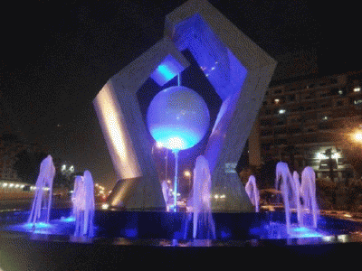 blue-illuminated sculpture/fountain.