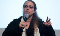 Photo of Tania Bruguera with microphone in hand