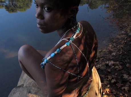 A young woman with beads. 