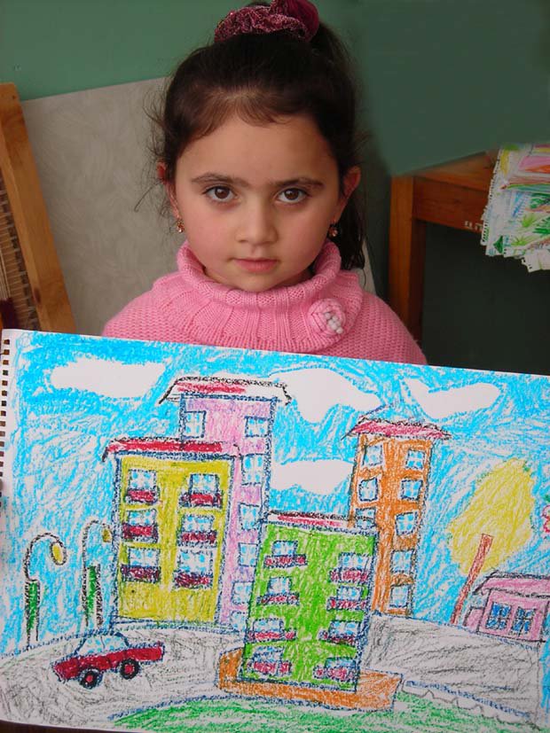 Tskhinvali girl with picture of buildings