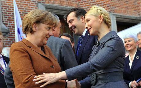Tymoshenko with German Chancellor Angela Merkel. Tymoshenko is expected to make gains in the polls.