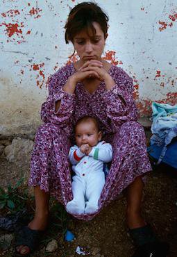 A teenage girl with her daughter as part of Romani Kosovar refugees in Montenegro. Nigel Dickinson/Open Society Foundations. All