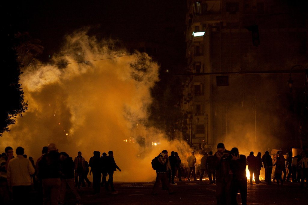 People are seen in front of huge plumes of smoke in Egypt's Tahrir Square