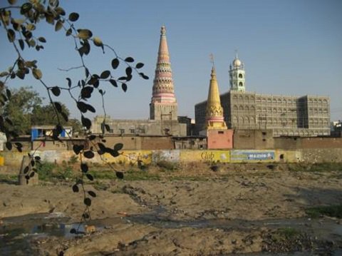 Two colourful conical towers and a minaret