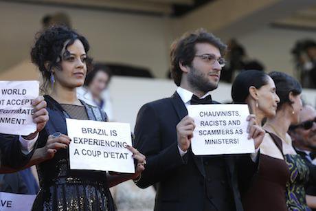 Cast of Aquarius hold placards protesting Brazil&#39;s political situation at Cannes Film Festival. Credit: Lionel Cironneau/AP/Pres