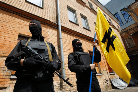 Fighters of the Azov battalion under the flag of the SNA featuring a wolf&#39;s hook. 