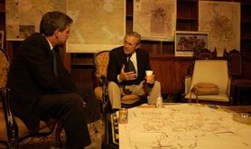 Bremer and Rumsfeld chat over some light refreshments, 2003. Wikimedia Commons. Public Domain.