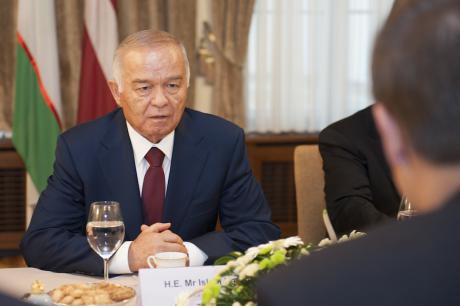 Uzbekistan&#39;s strongman, Islam Karimov  pictured at a regional summit in a suit and tie. He is an old looking man.