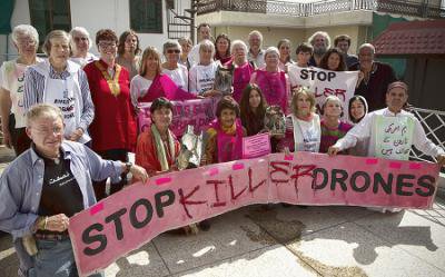 Men and Women surround a pink &#39;Stop Killer Drones&#39; banner