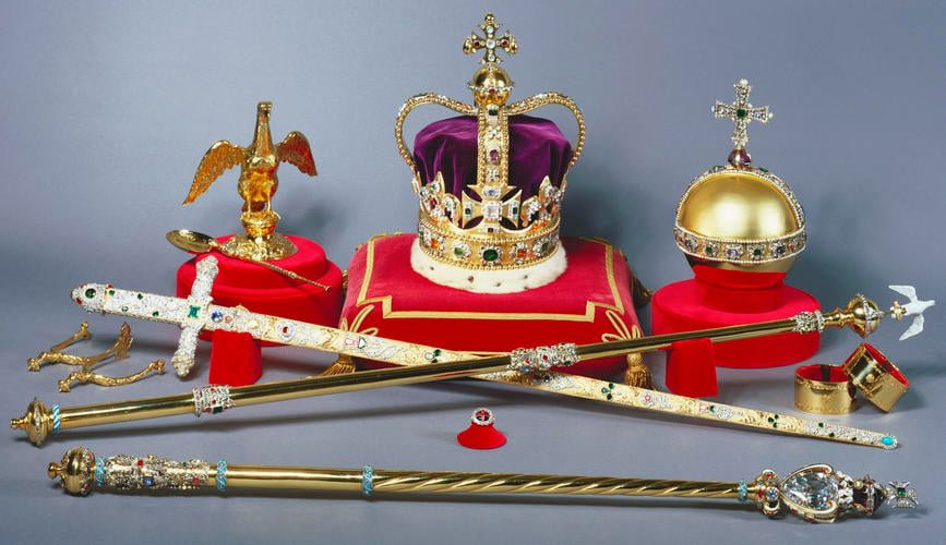 A crown, two golden sticks, a gold sword, a gold ball with a cross on top, and various other jewels