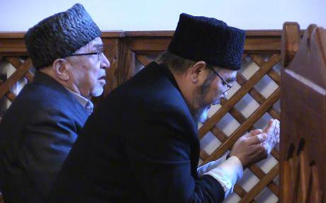 Two Muslim Tatars praying at mosque. 