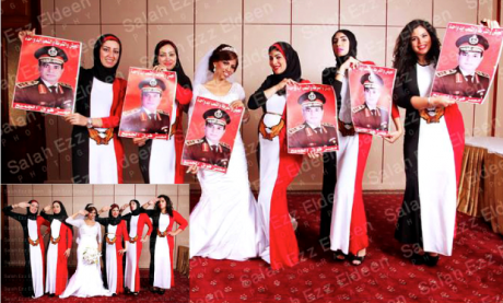 Six young women wearing dresses in the colours of the Egyptian flag (and one in a bridal dress) hold up posters of Sisi.