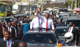 Kenyatta waves triumphantly to crowd