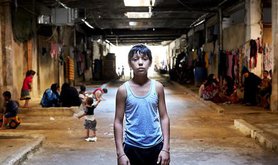 refugee boy in shelter in Lebanon