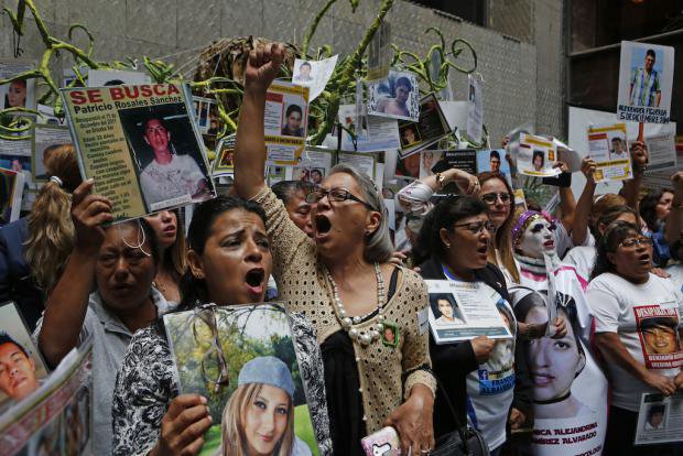 Women with photos of their children who disappeared in 2014 (Ayotzinapa)