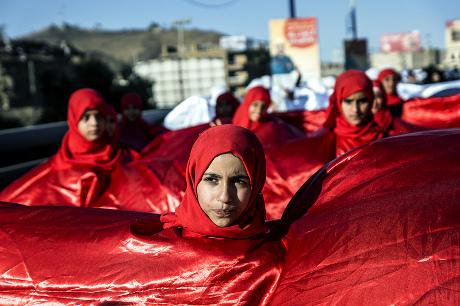 female demonstrators wrapped in red