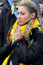 A female Maidan protester prays during a rally in Kyiv