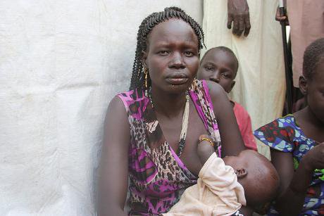 Refugee woman breastfeeding