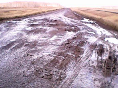 A road in Sargat Region, full of pot holes and cracks