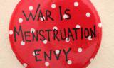 Red badge reading 'War is Menstruation Envy'